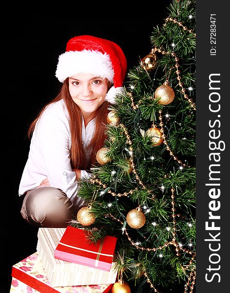 Girl with christmas tree and presents over dark