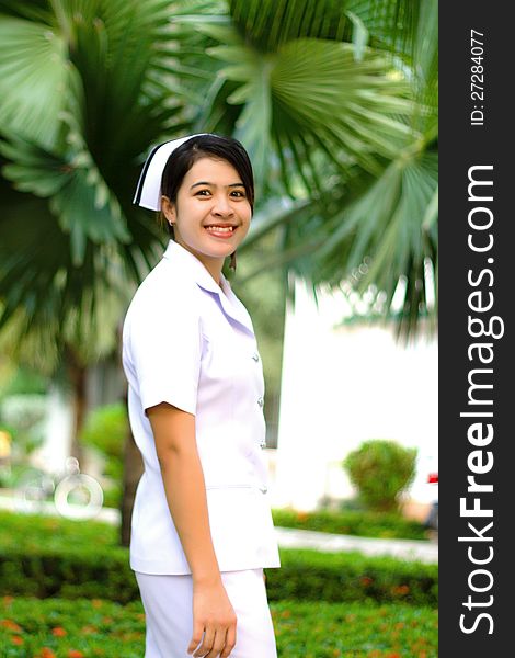 Smiling of Thai nurse on the green background