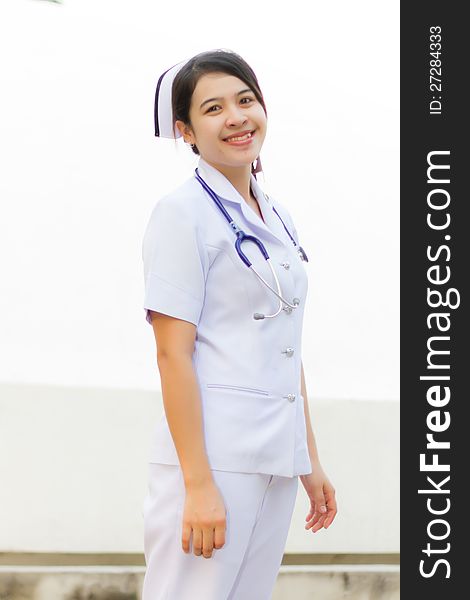 Thai nurse smiling with stethoscope in the garden