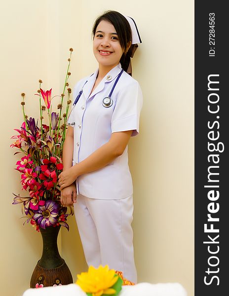 Thai nurse with flower in hospital