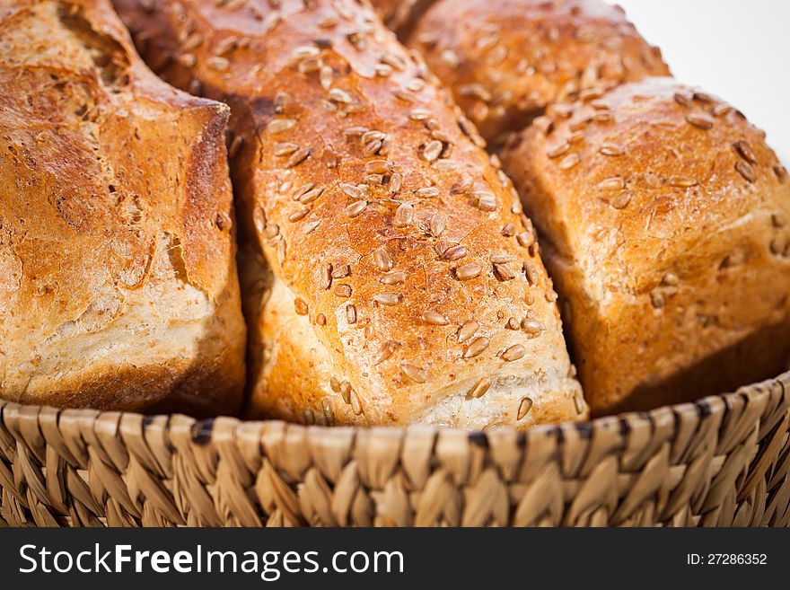 Loaf of bread with sunflower seeds in a basket. Shallow DOF. Loaf of bread with sunflower seeds in a basket. Shallow DOF