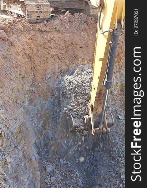 Description Backhoe digging in a quarry overlooking a section of the well. Description Backhoe digging in a quarry overlooking a section of the well.