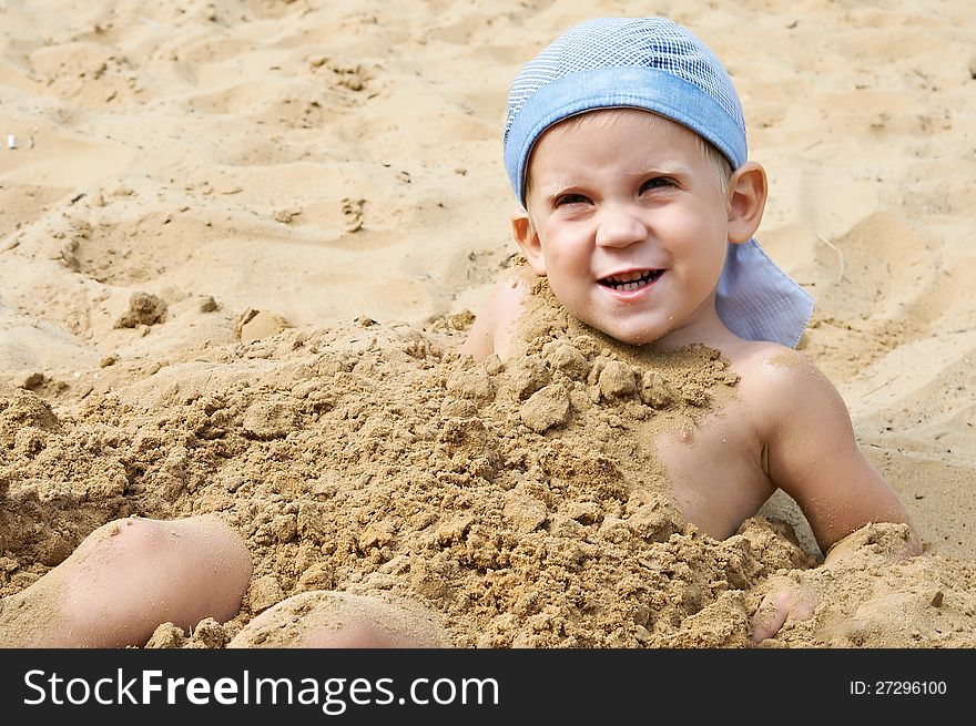 Little Boy Lying On The Sand