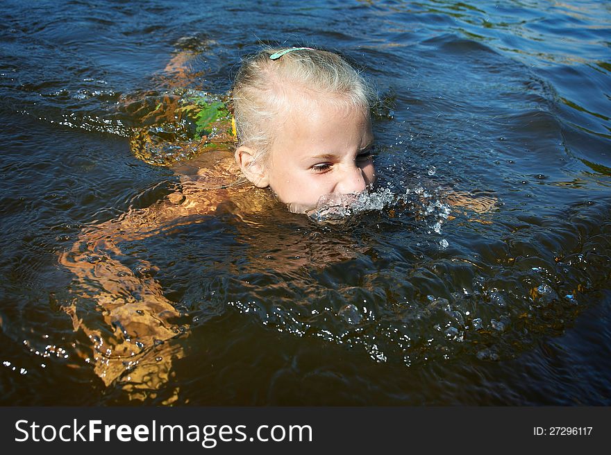 Little girl swimming in lake