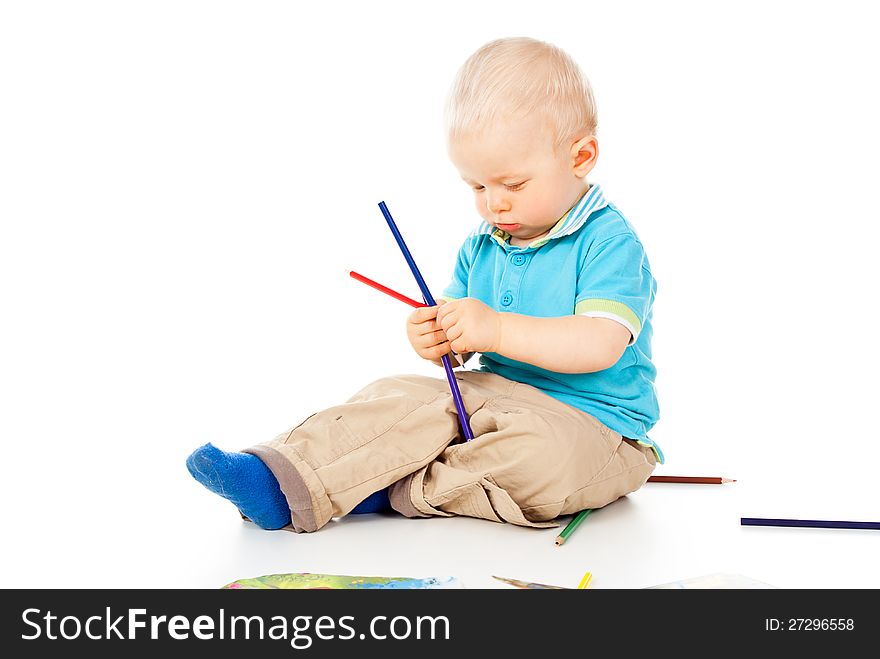 Portrait of a beautiful little boy with pencil