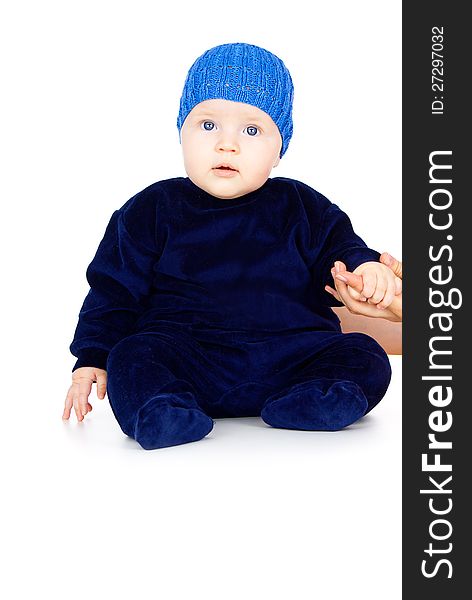 Little child sitting in a blue cap. Little child sitting in a blue cap