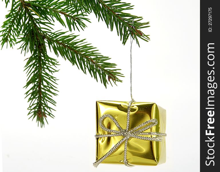 Christmas decoration - Gold gift hanged on twig. Christmas decoration - Gold gift hanged on twig