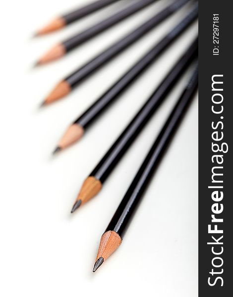 Six black pencils with white background