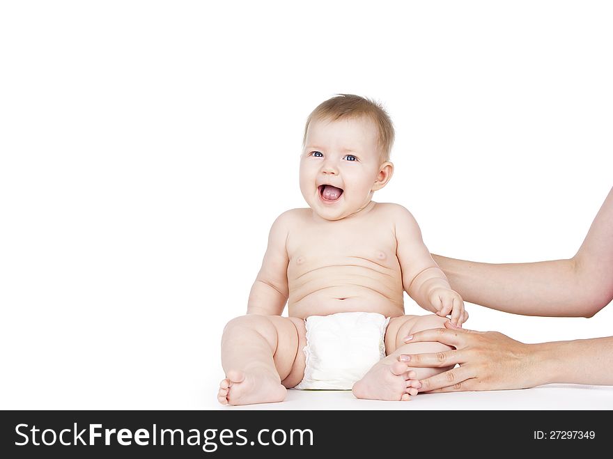 Baby laughing in diapers on white background
