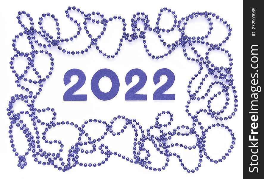 Violet felt numbers 2022 and beads around in trendy very peri color on white background. Flat lay for Valentines Day or New Year.