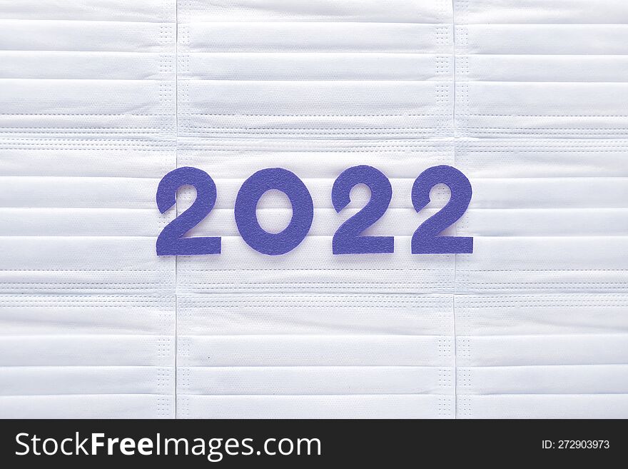 Violet Felt New Year Numbers 2022 On White Medical Masks Background. Inspired By Trendy Very Peri Color Of The Last Year 2022. Pla