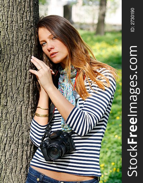 The girl-photographer in spring park. The girl-photographer in spring park