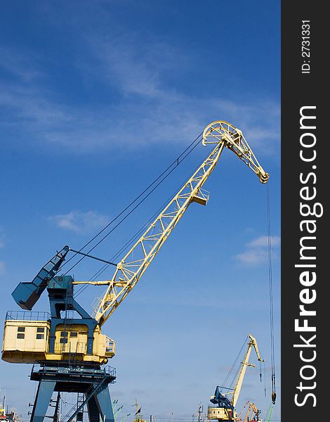 Port crane under blue skies