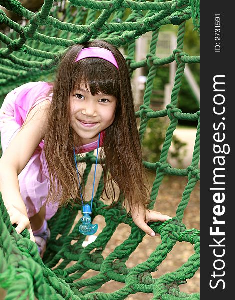 Cute girl in pink play in playground