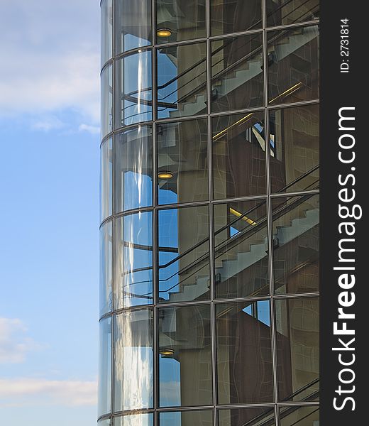 Stairs in a glass tower in front of blue sky. Stairs in a glass tower in front of blue sky