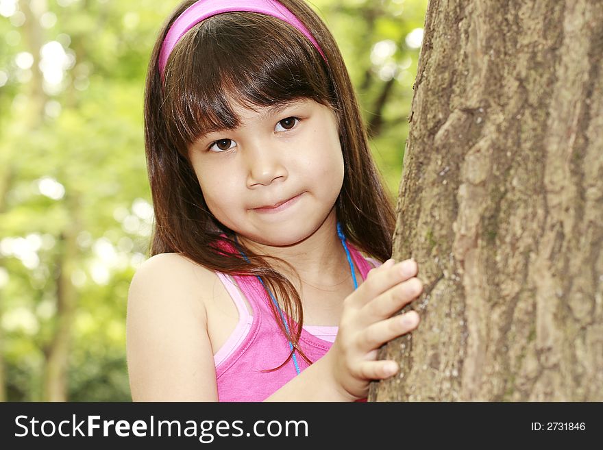 Girl in pink near the tree. Girl in pink near the tree