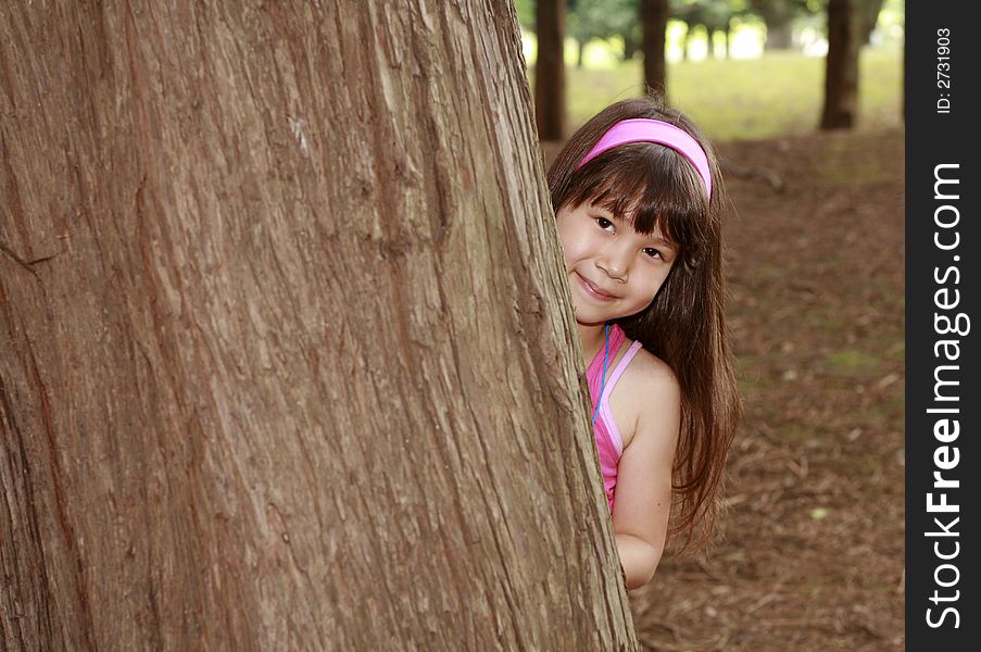 Girl in pink near the huge tree. Girl in pink near the huge tree
