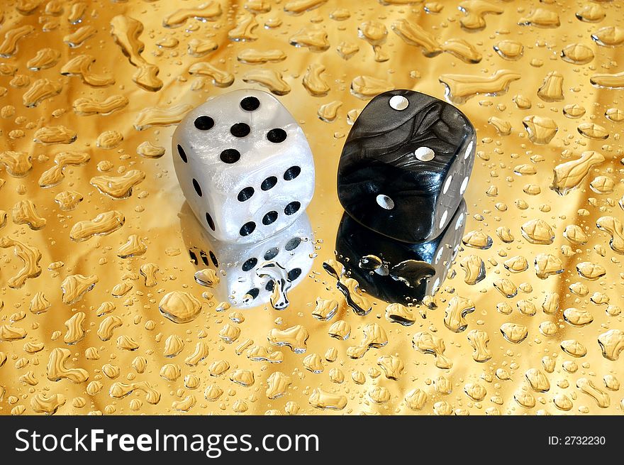 Dice on golden droplets background showing seven points. Dice on golden droplets background showing seven points