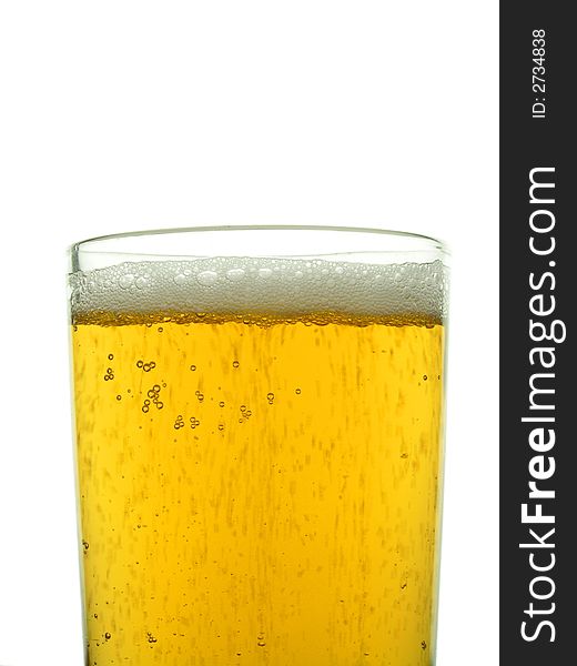 Close-up of glass of lager showing frothy head and bubbles