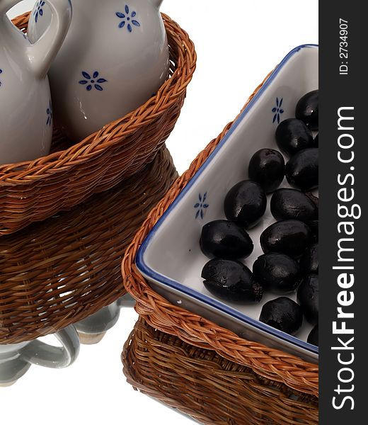 Olives in a ceramic dish in a basket, with oil jugs. Olives in a ceramic dish in a basket, with oil jugs