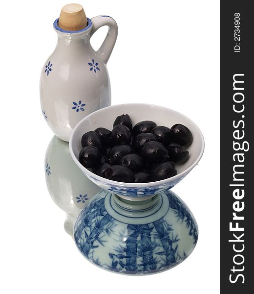 Olives in a ceramic dish with oil jug. Olives in a ceramic dish with oil jug