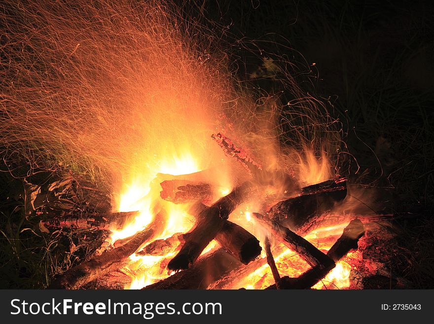 Camp fire at night, flame and spark traces, exposure time 8 sec. Camp fire at night, flame and spark traces, exposure time 8 sec