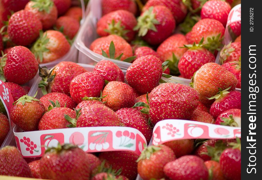 Red strawberries in plastic boxes.