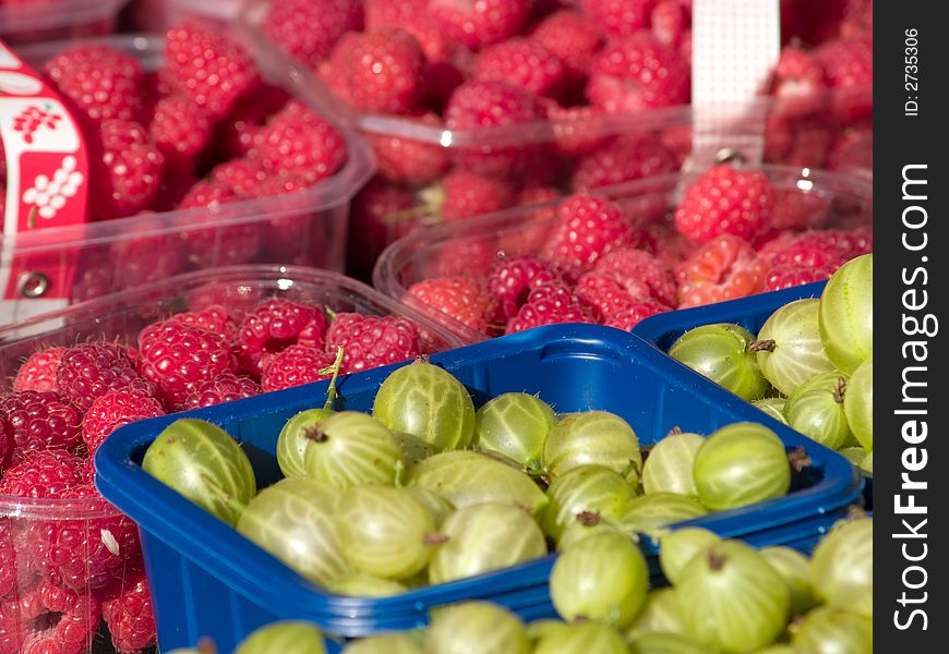 Gooseberries and raspberries at market