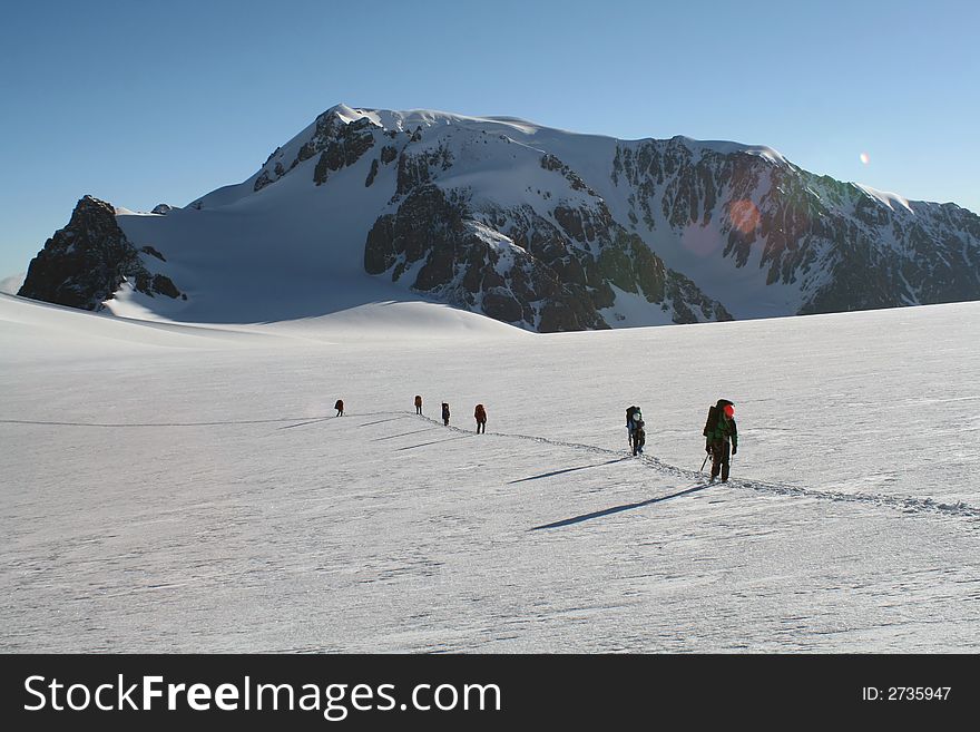 Group of mountaineers walking on a glacier. Group of mountaineers walking on a glacier