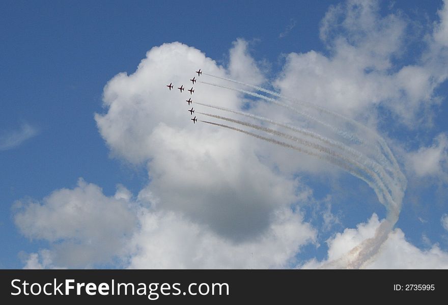 British military Hawk stunt jets in a display, with smoke trails. British military Hawk stunt jets in a display, with smoke trails.