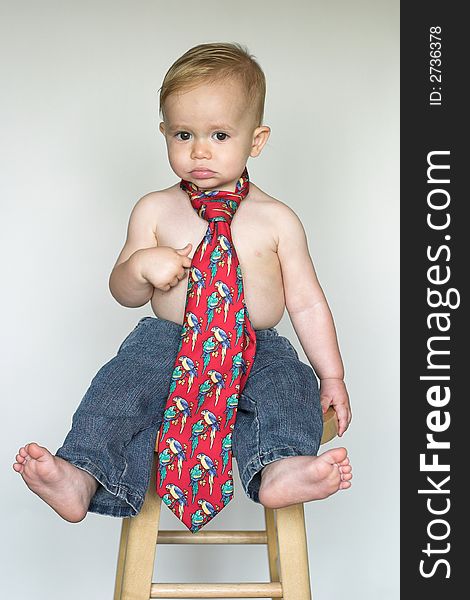 Image of cute toddler wearing jeans and a tie. Image of cute toddler wearing jeans and a tie