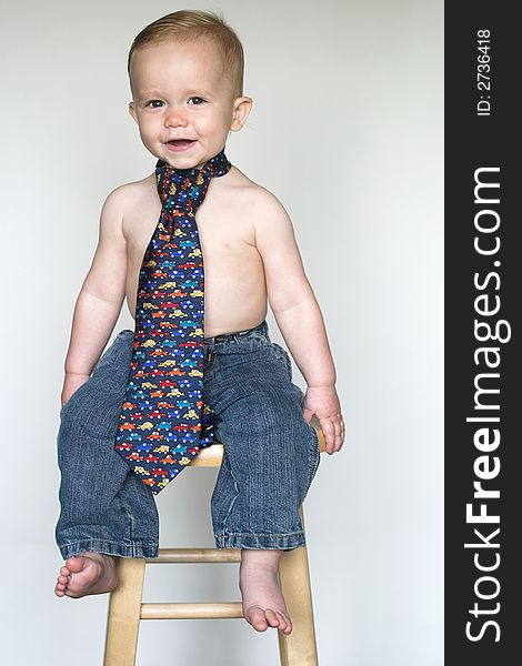 Image of cute toddler wearing jeans and a tie. Image of cute toddler wearing jeans and a tie