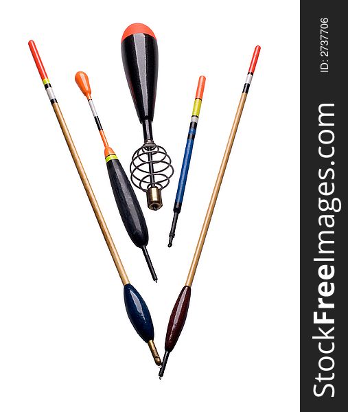 Fishing accessories of different colors lay on a white background. Fishing accessories of different colors lay on a white background