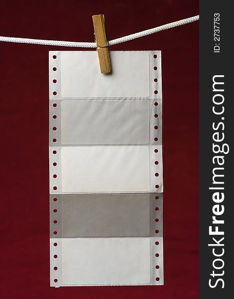 Perforation paper attach clothes-peg to rope on venous background