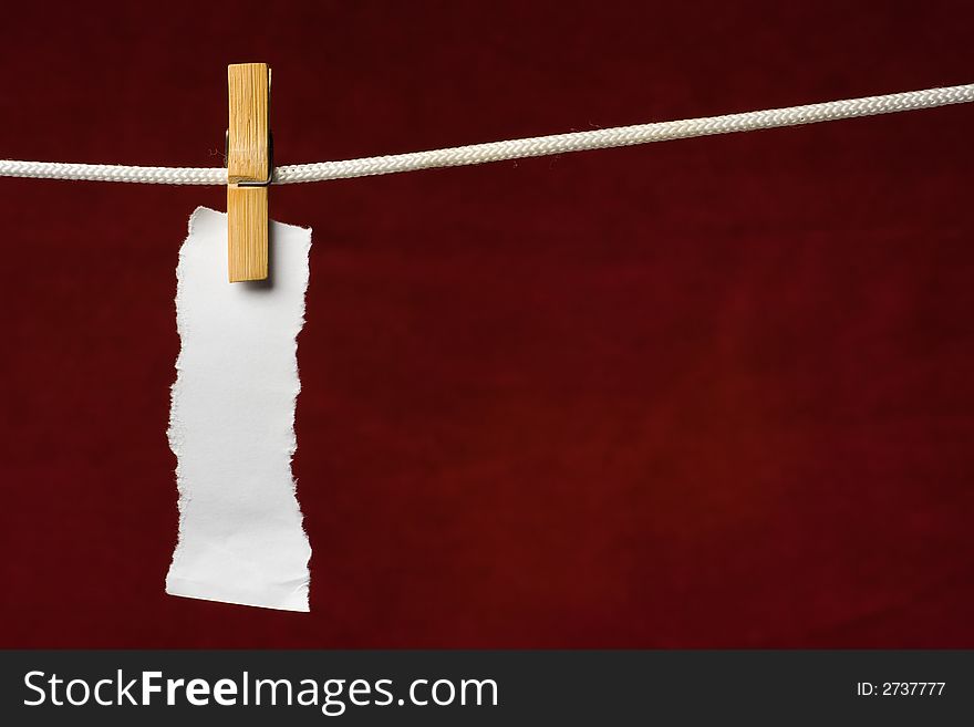 Scrap paper attach clothes-peg to rope on venous background