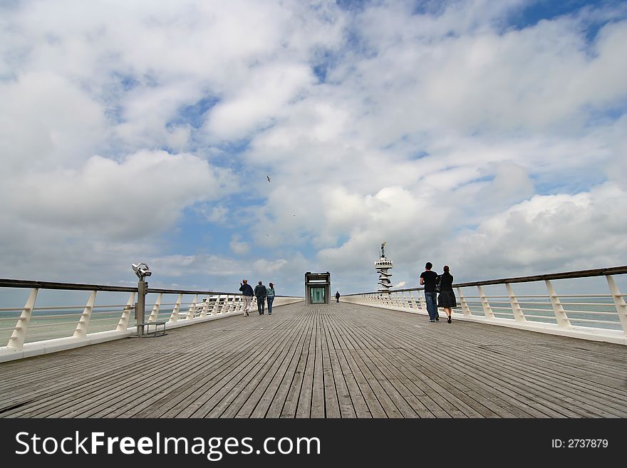 People walking on a pier