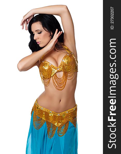 Beautiful belly dancer wearing a gold and blue costume. Her face is in profile, her eyes are closed and she is framing her face with her hands. Isolated on white. Clipping path included.