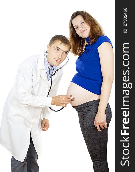 Doctor listening to pregnant woman&#x27;s belly