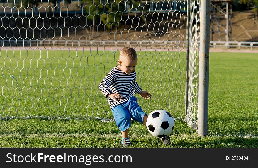 Little Boy Kicking A Ball