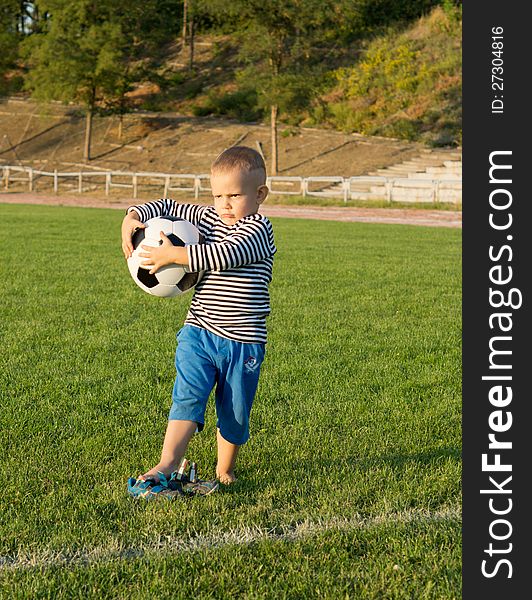 Little boy holding a soccer ball