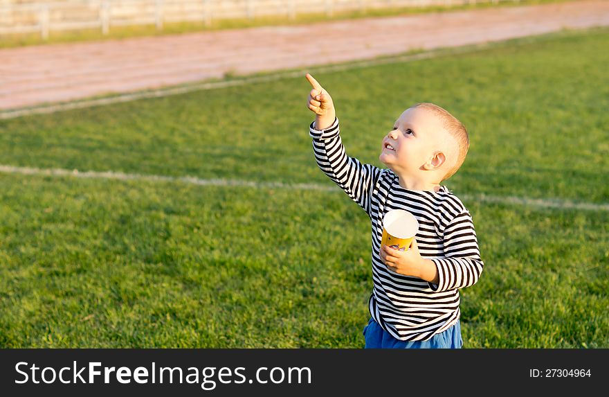 Little boy pointing at the sky