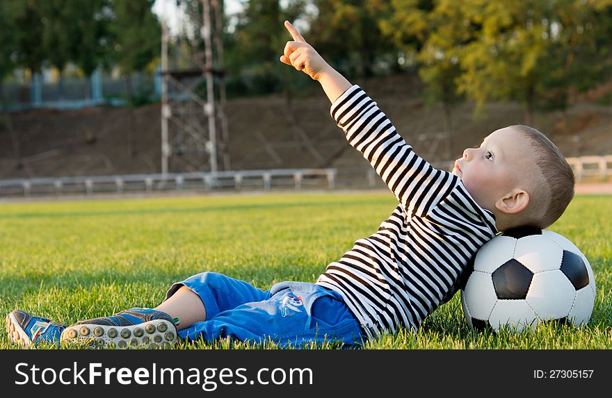 Small boy pointing at the sky