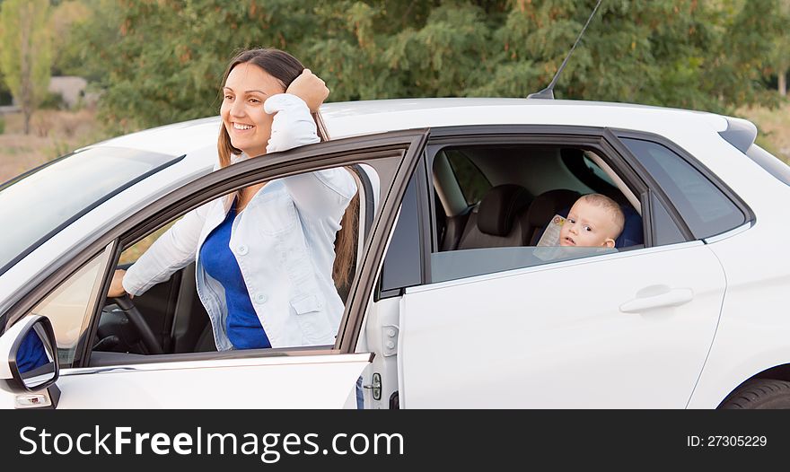 Mother smiling alongside her car