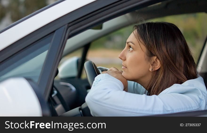 Woman waiting patiently in her car