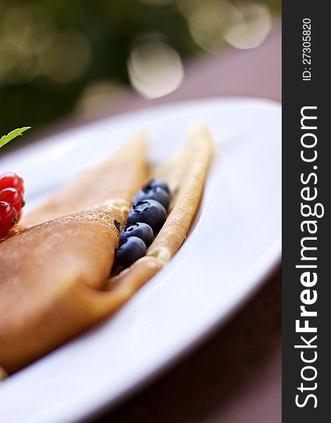 A crepe filled with blueberry. A crepe filled with blueberry