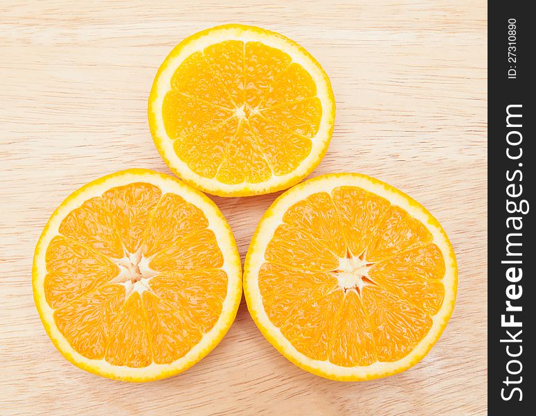 Orange fruits on wooden board.