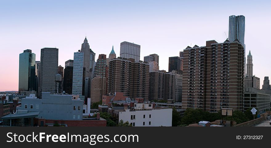 Panoramic view of Manhattan, New York, at twilight, from Brooklyn Bridge to Financial District. Panoramic view of Manhattan, New York, at twilight, from Brooklyn Bridge to Financial District