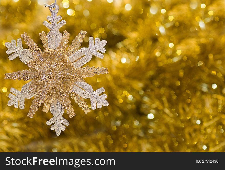 On a gold background shiny big beautiful snowflake. On a gold background shiny big beautiful snowflake