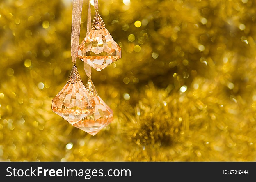 On a gold background brilliant yellow transparent bells. On a gold background brilliant yellow transparent bells