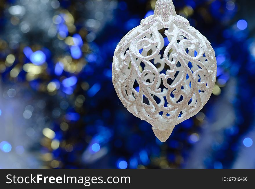 On a blue background with a large white lights Christmas Toy. On a blue background with a large white lights Christmas Toy